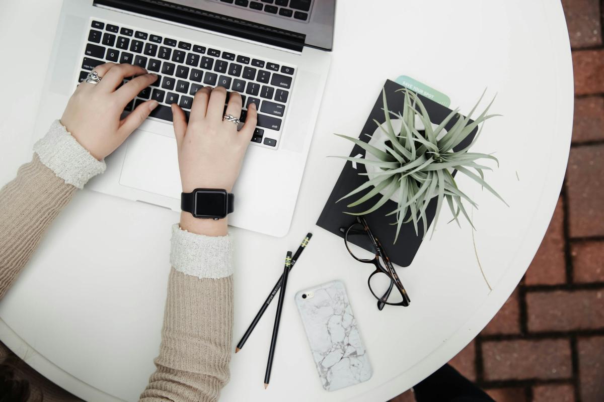 Laptop on table with plant